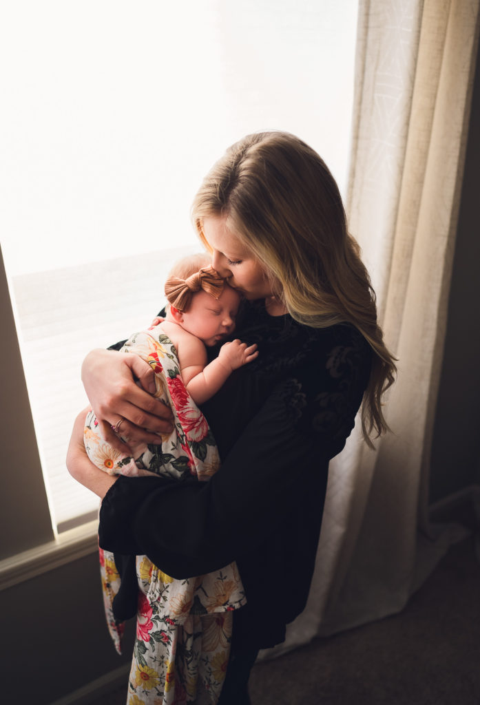 Lifestyle newborn photograph of mother and baby