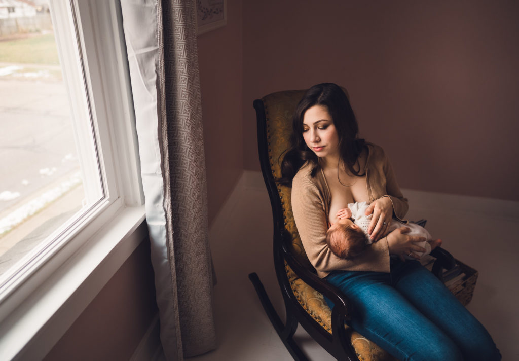 Lifestyle newborn session, shot of mom breastfeeding