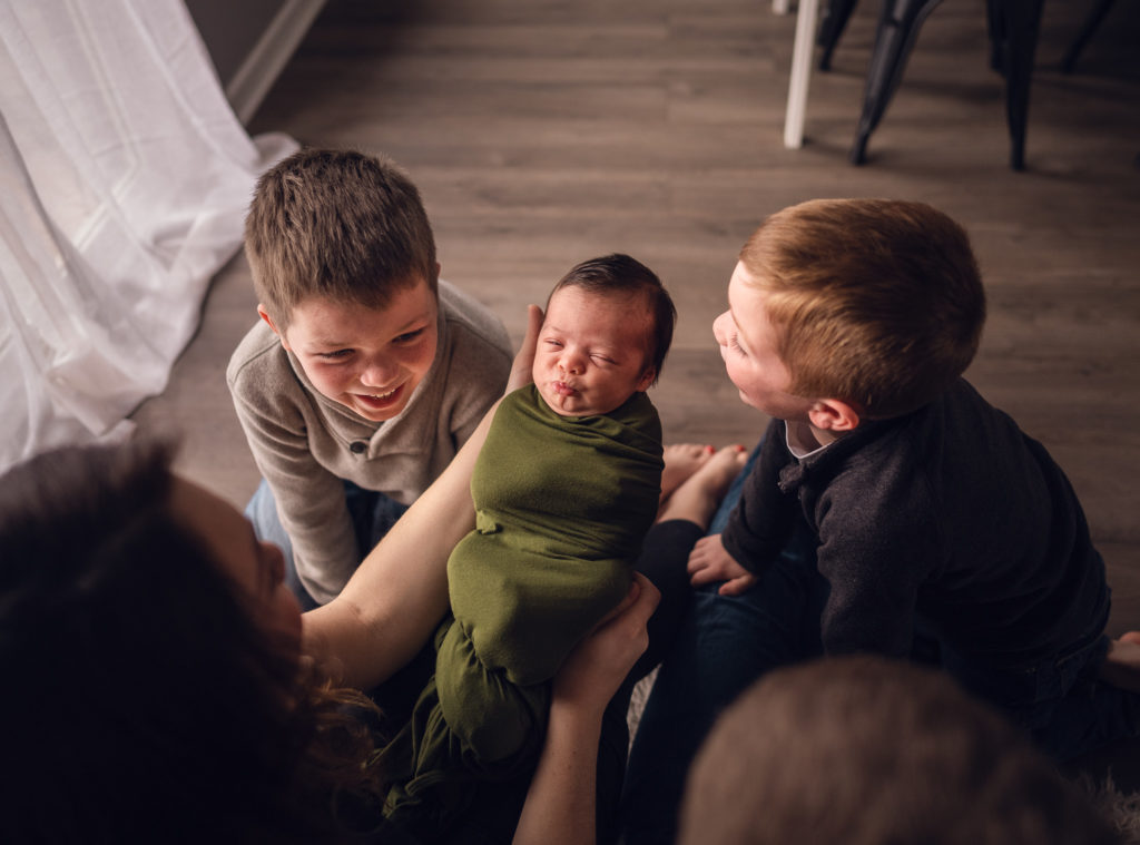 Lifestyle newborn photo with brothers