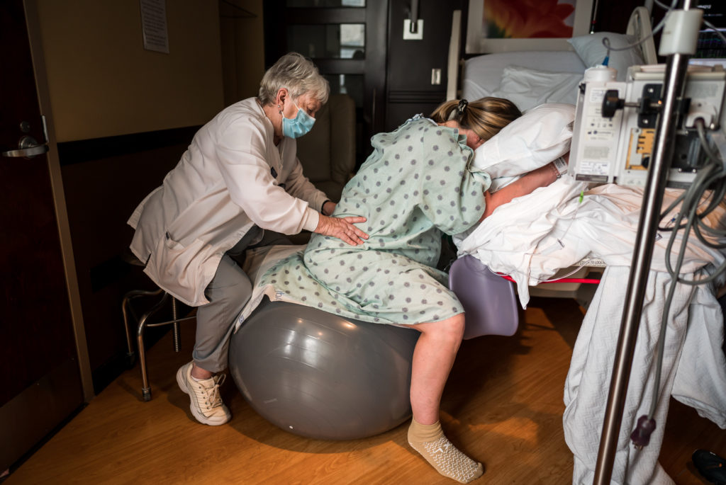 Birthing woman receiving doula support in the hospital